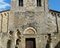 Abbadia a Isola - Facciata della chiesa romanica (si notino i resti del portale anticamente “gemino”, cioè doppio, tipico delle chiese di pellegrinaggio).