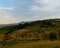 Raggiungo una piccola altura dove lo sguardo si perde sulla Val d’Orcia illuminata dalla prima luce del sole.